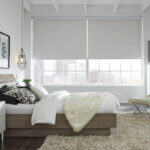 Lutron automated room-darkening shades in a loft bedroom.